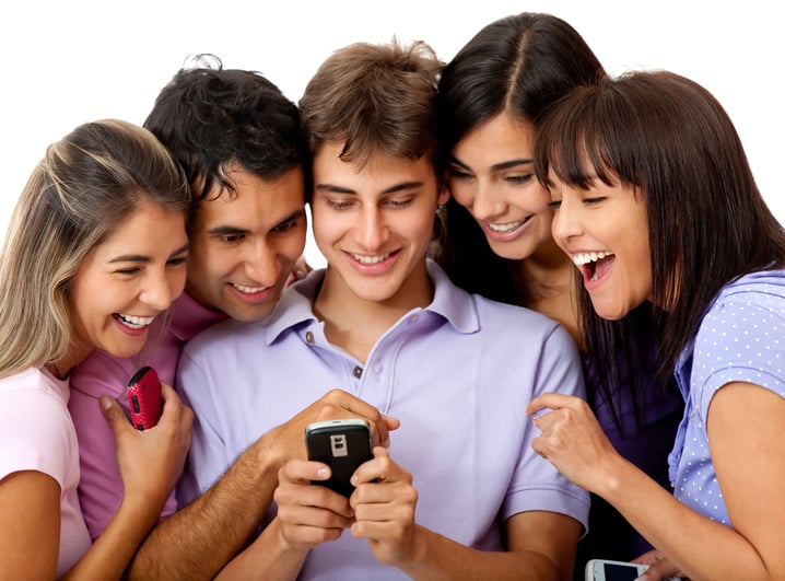 Group of people on a cell phone using social media